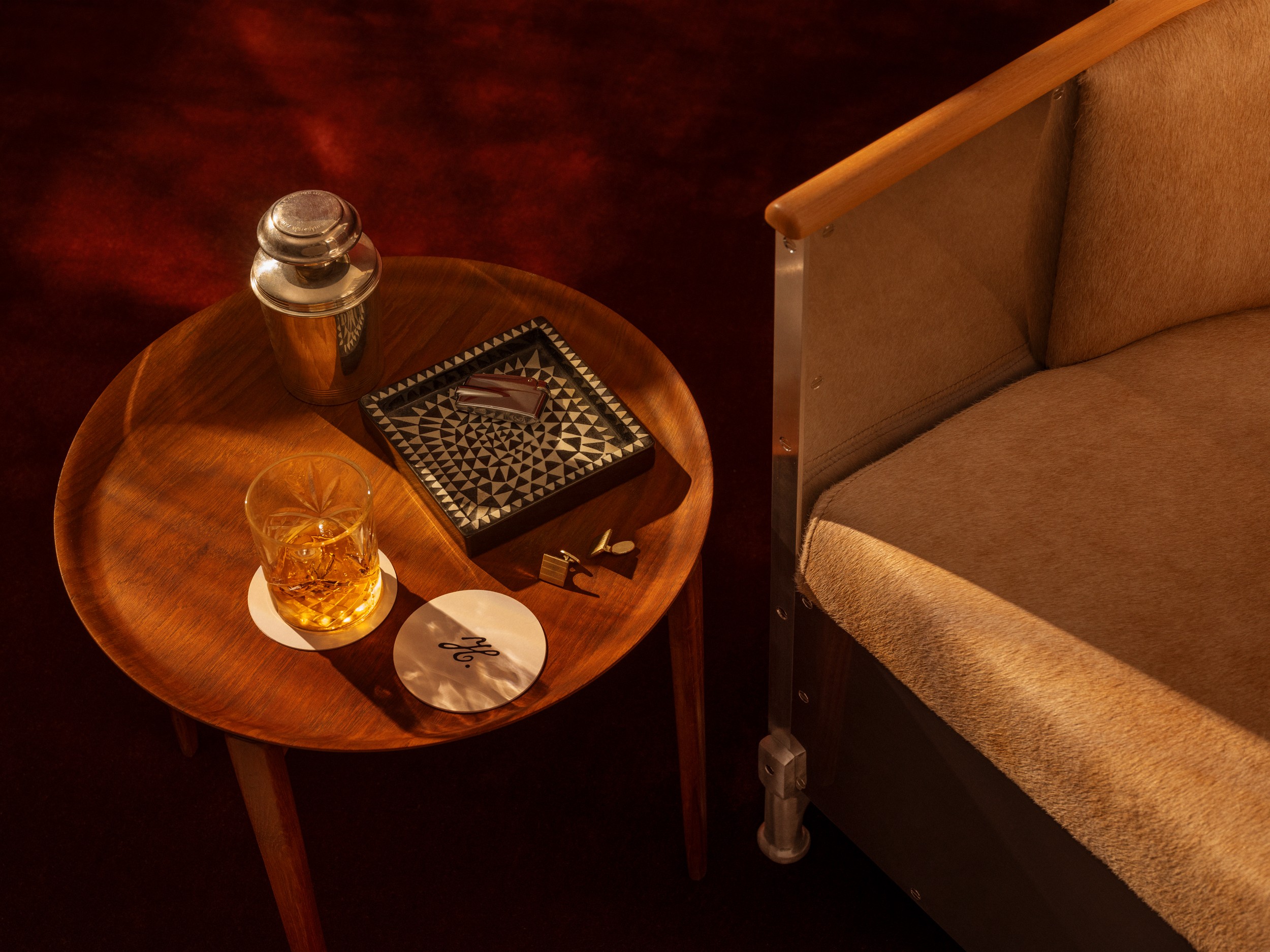 A chair, a drink on a side table